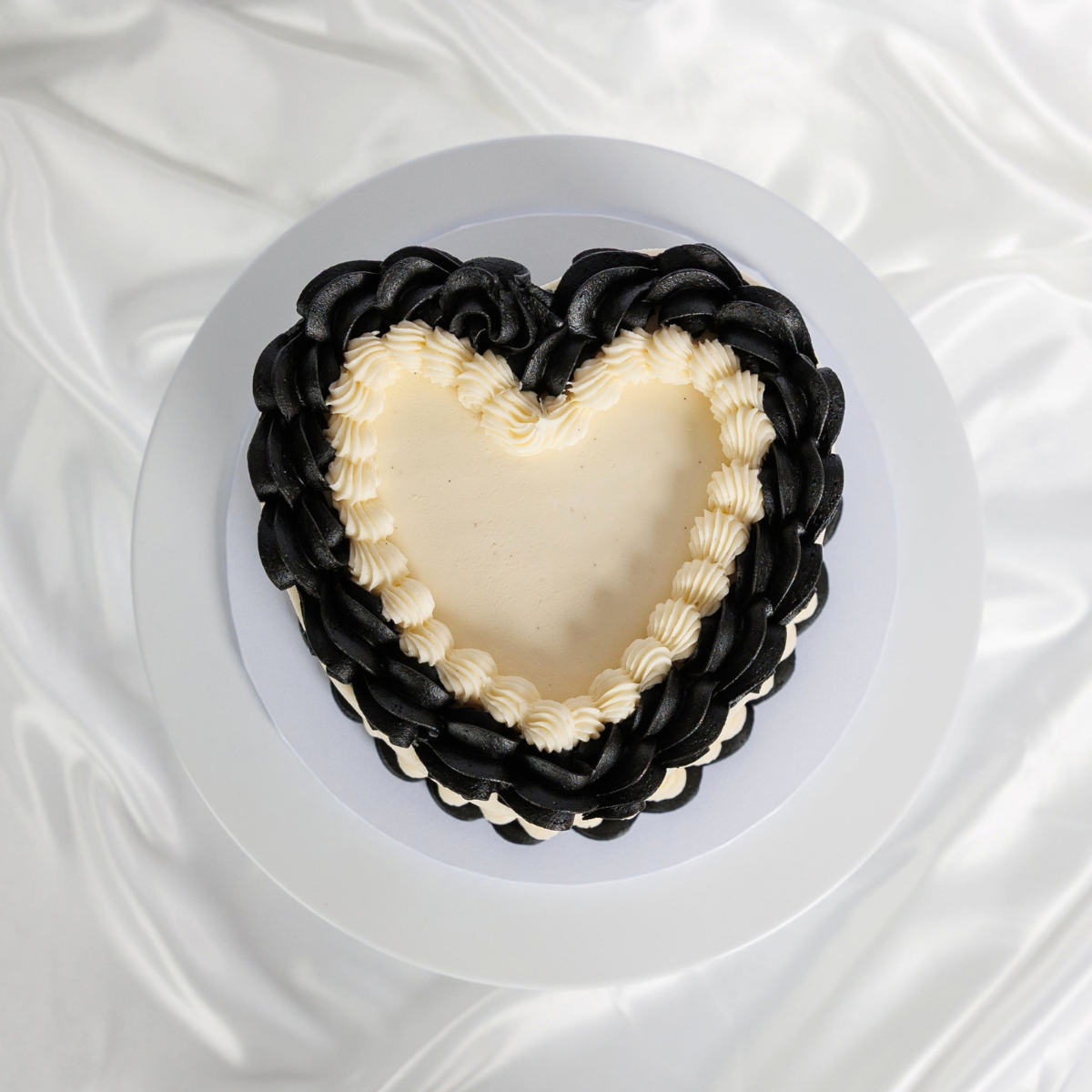 White Vintage Heart Cake with black buttercream trim, top view
